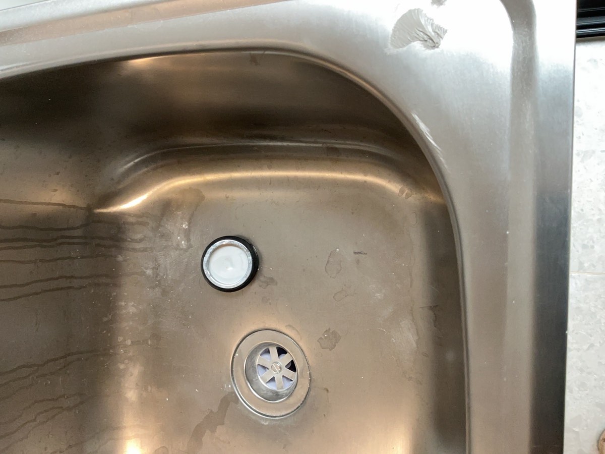 Marks and damages to a laundry trough, recorded during a handover inspection in Oran Park